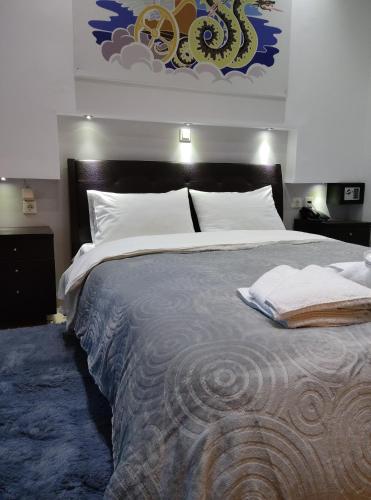 a bedroom with a large bed with white pillows at Anemi Leros Apartments 3 in Panteli