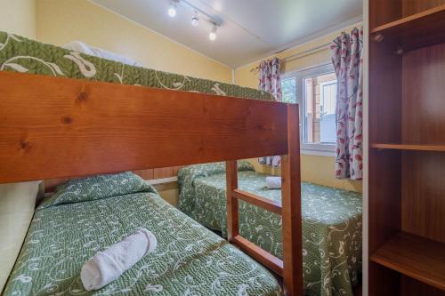 a bedroom with two bunk beds in a room at Bungalow D in Pontevedra