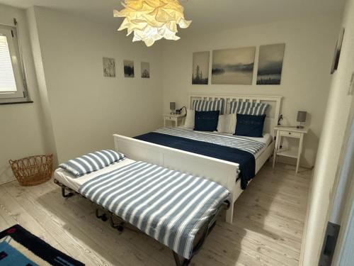 a bedroom with two beds and a chandelier at Ferienwohnung Bäumchenblick in Müllheim