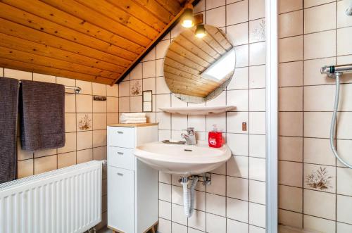 a bathroom with a sink and a mirror at Fewo Georg in Pfullendorf