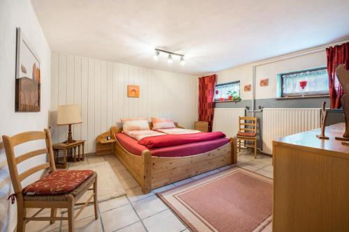 a bedroom with a bed and a table and chairs at Ferienwohnung Loy in Rastede