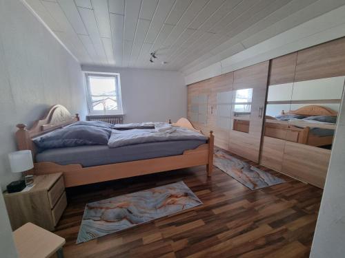 a bedroom with two beds and a wooden wall at Ferienwohnung Familie Kleinbauer in Wirsberg