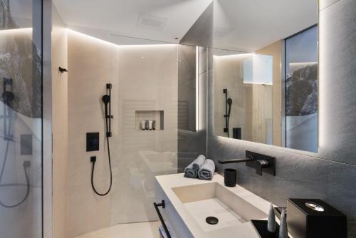 a bathroom with a sink and a shower at Chalet Ski in Selva di Val Gardena