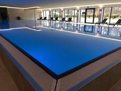 a large swimming pool with a blue shuffleboard at Gardensuite Binz in Binz
