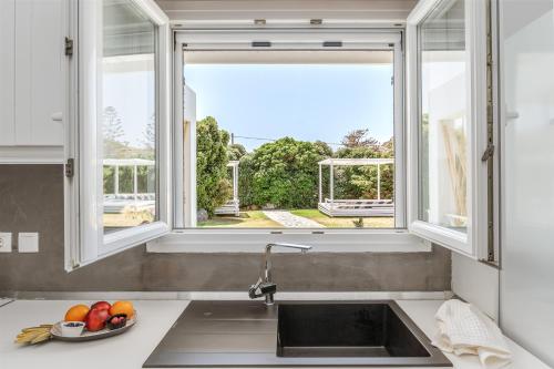 a kitchen with a sink and a window at Ow Andros Suite 2,Private Whirlpool in Andros