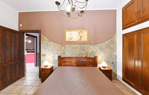 a bedroom with a bed and a chandelier at Villa Parisi con piscina in Syracuse