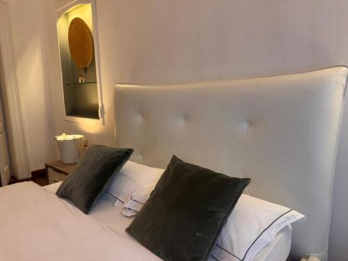 a bedroom with a white bed with two pillows at queen 24 in Taranto