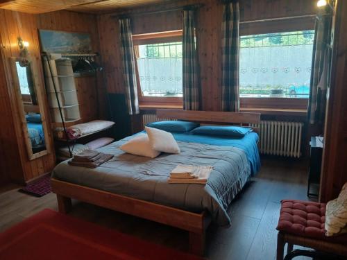 a bedroom with a bed with pillows on it at Maison Olga - La Roisette in Valtournenche