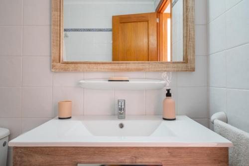a bathroom with a white sink and a mirror at Apartamentos Karin 2ºd in Cala d´Or