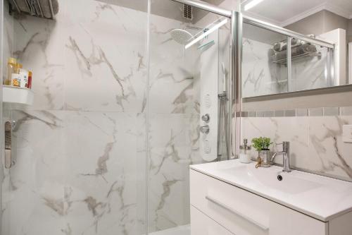 a white bathroom with a shower and a sink at Casa Ana in Santa Úrsula