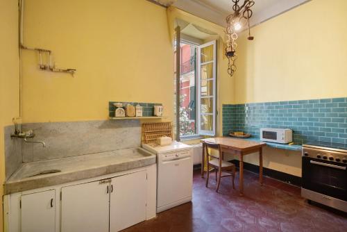 a kitchen with a sink and a table in it at Piazza 100 Croci in Bonassola
