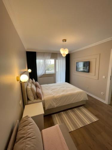 a bedroom with a large bed and a couch at Steaua ALBA CAROLINA in Alba Iulia