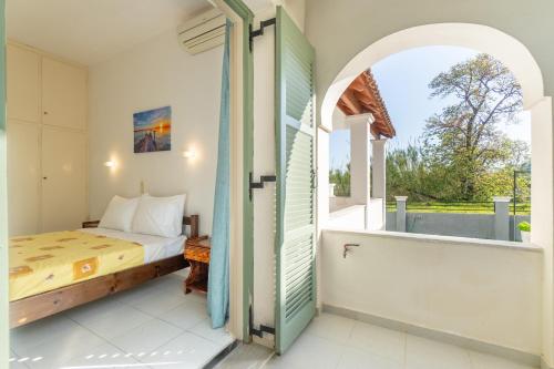 a bedroom with a bed and an open window at Olivea Apt 1 in Acharavi