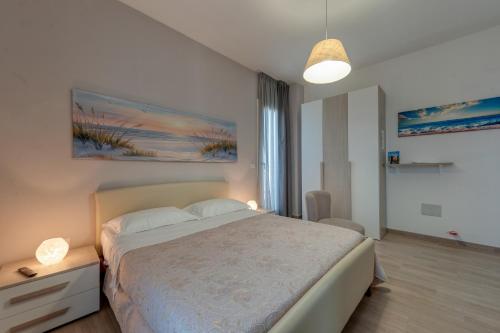 a bedroom with a large bed and a large window at Meravigliosalento in Squinzano