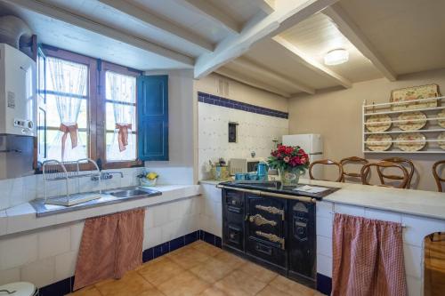a kitchen with a sink and a counter top at Casa La Calleja in Arzúa