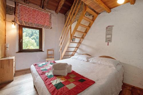 a bedroom with a bed with a quilt on it at Le Fratte in Pertica Alta