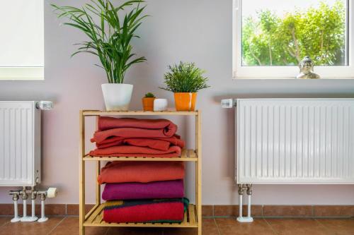 a stack of towels on a shelf in a bathroom at Ferienhof Dethlefsen in Pellworm