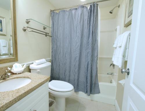 W łazience znajduje się toaleta, umywalka i prysznic. w obiekcie The Cove at Yarmouth w mieście West Yarmouth
