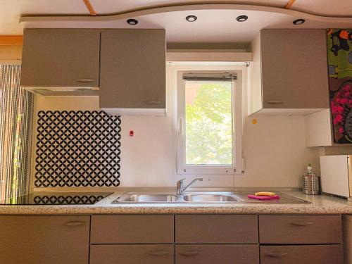 a kitchen with a sink and a window at Le sorgenti - Mobile Home 46 in Palazzuolo sul Senio