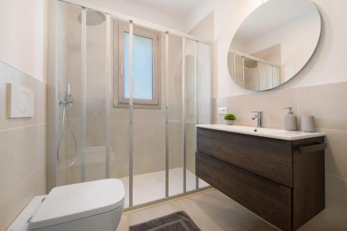 a bathroom with a shower and a toilet and a sink at Residence Eleonora in Garda