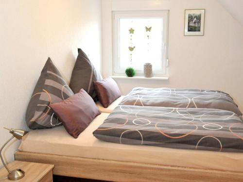 a bed sitting in a room with a window at Ferienwohnung Bock Feldmannshof in Drolshagen