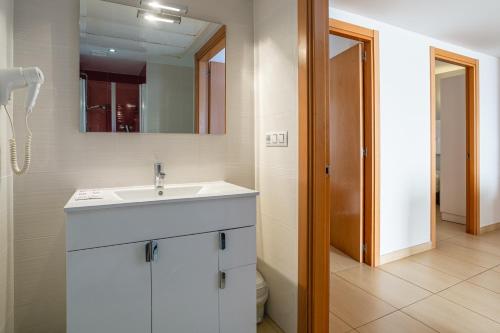 a bathroom with a sink and a mirror and a toilet at S23 Sa Caleta in Lloret de Mar