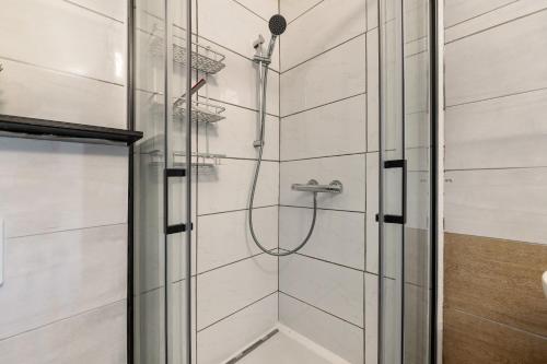 a shower with a glass door in a bathroom at Haus Zum Stumpfen Turm mit Sauna in Morbach