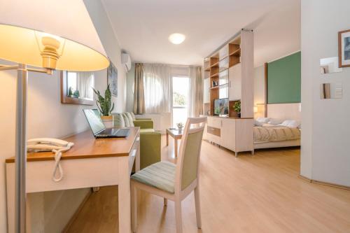 a small apartment with a desk and a bedroom at PrimeStayBudapest in Budapest