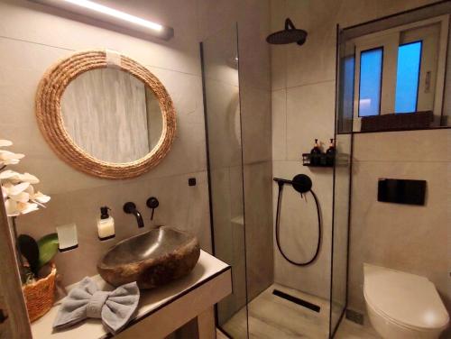 ein Badezimmer mit Waschbecken und Dusche in der Unterkunft Arokaria Studios in Gaios