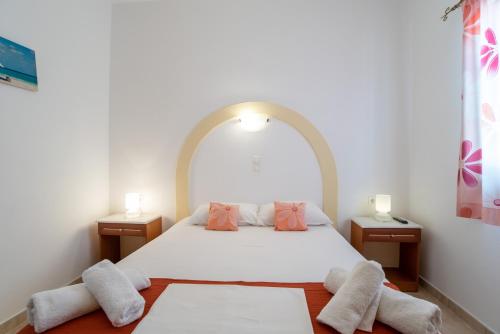 a bedroom with a white bed with two night stands at Mesaria Home in Donoussa