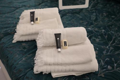 a pile of towels sitting on top of a bed at Eralight21 Apartments in Bari