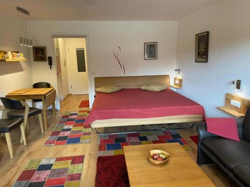 a bedroom with a bed and a table and a couch at Ferienwohnung Inzell mit Bergblick in Inzell