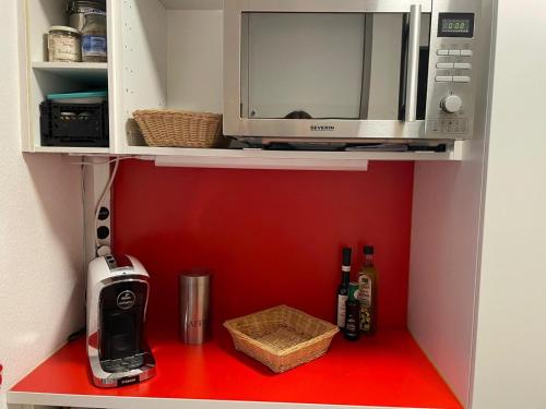 a microwave sitting on a shelf in a kitchen at Ferienwohnung Inzell mit Bergblick in Inzell