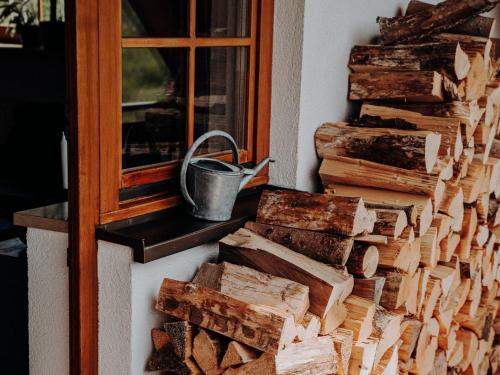 a pile of fire wood next to a window at Ferienwohnung Wälderliebe in Lenzkirch