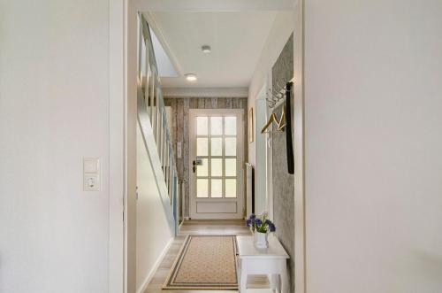 a hallway of a home with a door and a window at Huus Karoline in Junkersrott