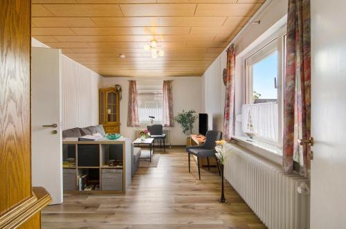 a hallway with a desk and a window at Huus Karoline in Junkersrott