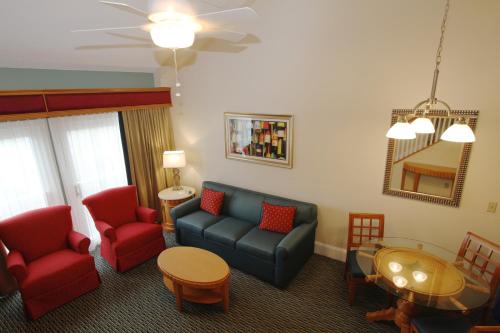 a living room with a couch and chairs and a table at The Cove at Yarmouth in West Yarmouth