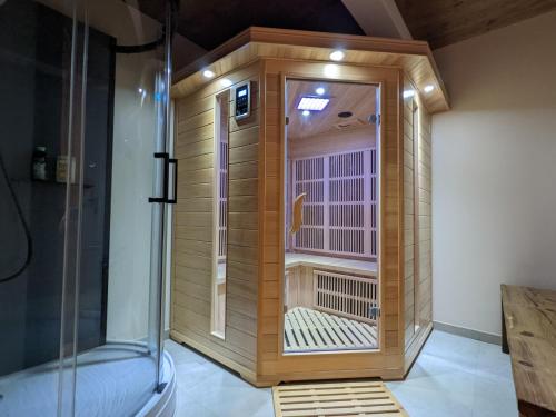 a shower with a wooden cage in a room at Chalet Friwi in Saint-Jean-de-Sixt