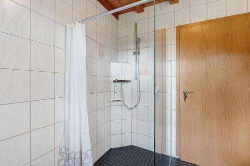 a shower with a shower curtain in a bathroom at Auszeit in Donaueschingen