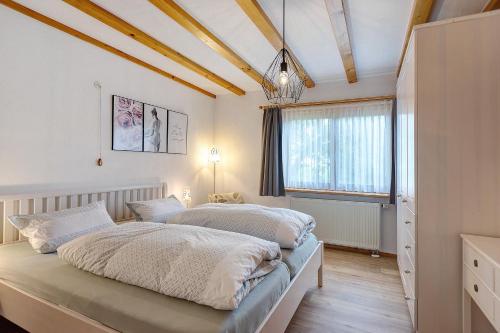 a bedroom with two beds and a window at Auszeit in Donaueschingen
