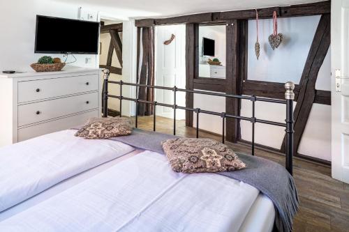 a bedroom with a bed with two pillows on it at Gästehaus Vis à Vis in Wallhausen