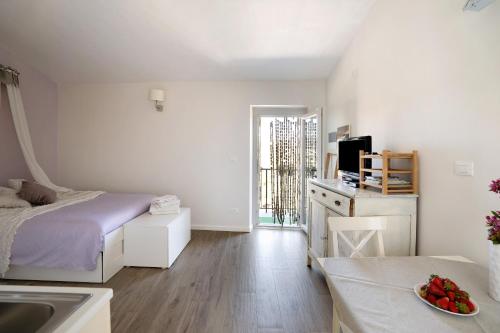 a white bedroom with a bed and a sink at Rosadimaggio Violetta in Arcola