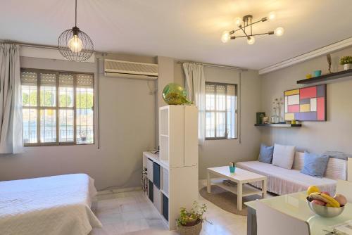 a living room with a bed and a couch at Casa Curro en Baena in Baena