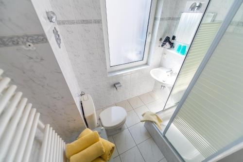 a bathroom with a toilet and a sink and a shower at Villa Bella Vista - Meerblick 2 in Sassnitz