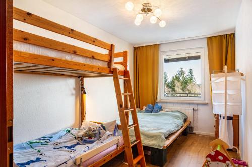 a bedroom with two bunk beds and a window at Wohnung Fuchsenstein-Foxy in Spiegelau