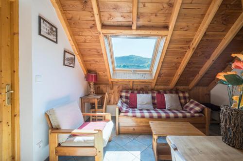 a living room with a couch and a window at La Mouliniere 1 in Valloire