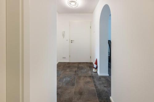 a hallway with white walls and a tile floor at Heidis Dihei in Büsingen