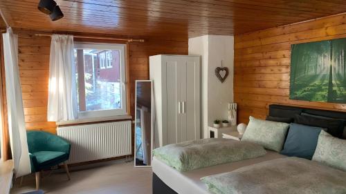 a bedroom with a bed and a window at Ferienhaus mit Sauna am Waldrand in Friedrichroda