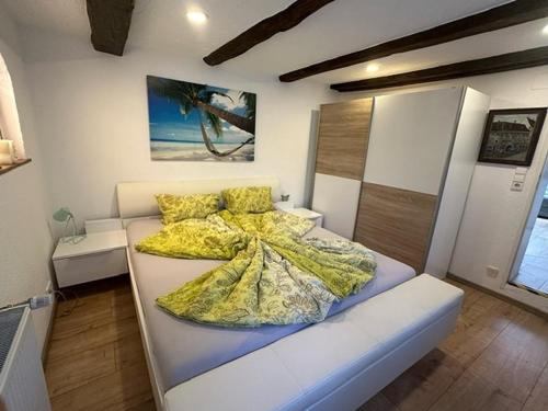 a bedroom with a bed with a yellow comforter at Ferienwohnung Insel Reichenau in Rheinstraße