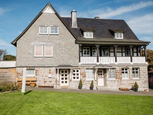 a large brick house with white doors and windows at Ferienwohnung Wennetal in Schmallenberg